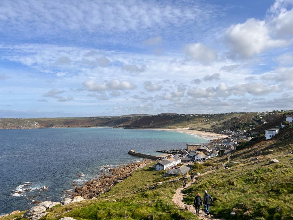 The South West Coastal Path - Cornwall - a couple and their dog walking on the path